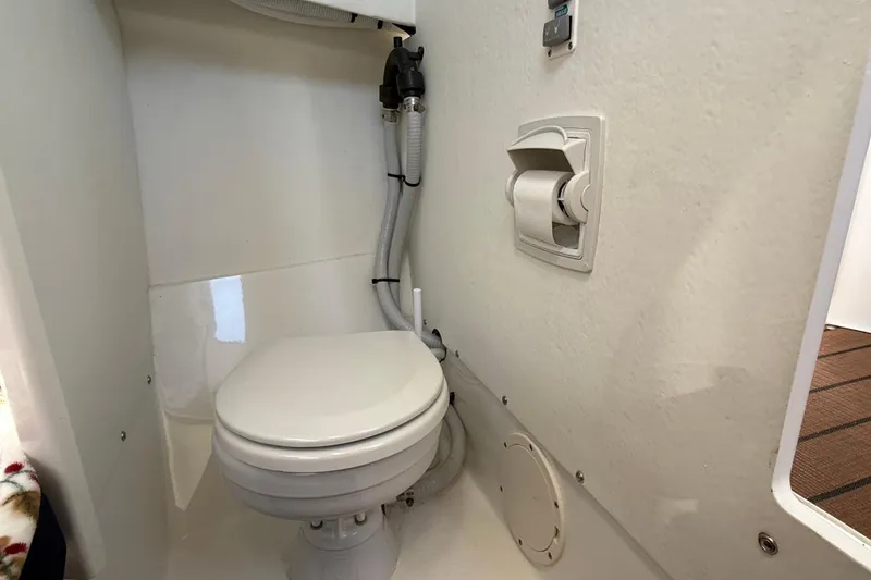Slide: The Image of 2023 Rosborough 246 Halifax boat bathroom with compact toilet and wall-mounted toilet paper holder. - 34