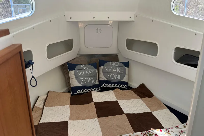 Slide: The Image of Cozy cabin interior of 2023 Rosborough 246 Halifax boat with "No Wake Zone" pillows. - 3