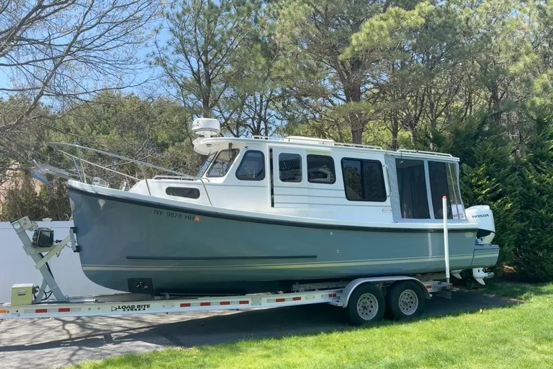 Slide: The Image of 2023 Rosborough 246 Halifax boat on trailer, surrounded by trees. - 66