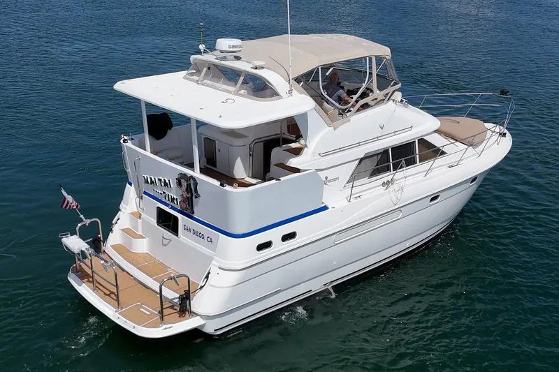 Slide: The Image of 1996 Cruisers Yachts 3650 Aft Cabin cruising on calm blue waters. - 12
