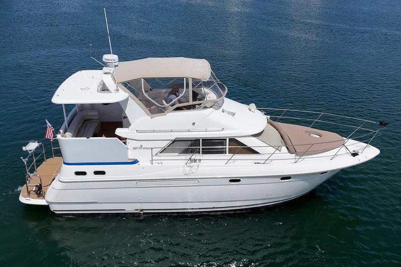 Slide: The Image of 1996 Cruisers Yachts 3650 Aft Cabin on calm blue water, side view. - 13