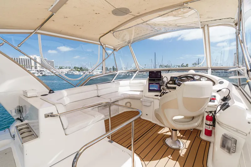 Slide: The Image of 1996 Cruisers Yachts 3650 Aft Cabin helm with marina view, featuring modern controls and seating. - 15
