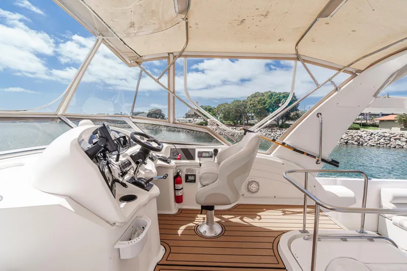 Slide: The Image of 1996 Cruisers Yachts 3650 Aft Cabin helm with scenic waterfront view. - 16