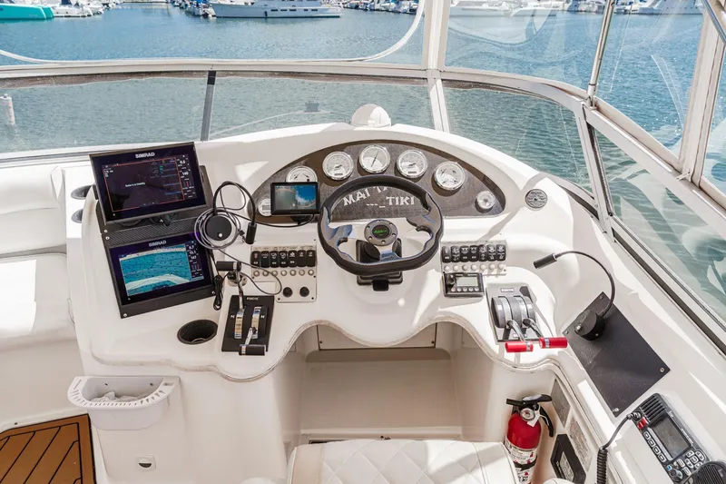 Slide: The Image of 1996 Cruisers Yachts 3650 Aft Cabin helm with navigation equipment and marina view. - 18