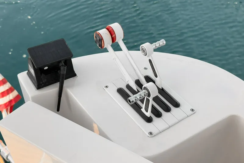 Slide: The Image of Throttle controls on a 1996 Cruisers Yachts 3650 Aft Cabin, overlooking water. - 24