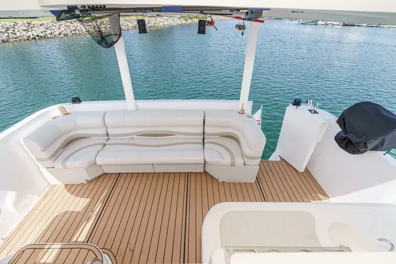 Slide: The Image of Spacious deck of 1996 Cruisers Yachts 3650 Aft Cabin with comfortable seating and scenic water view. - 25
