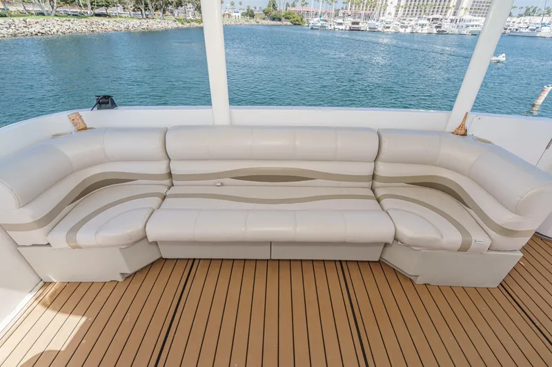 Slide: The Image of Luxurious seating on 1996 Cruisers Yachts 3650 Aft Cabin, overlooking serene marina waters. - 26