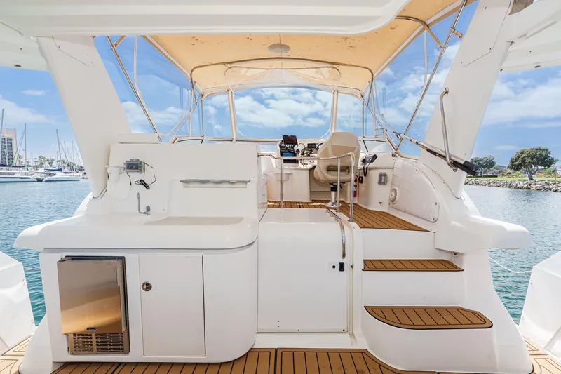 Slide: The Image of 1996 Cruisers Yachts 3650 Aft Cabin with spacious deck and helm, docked in marina. - 27