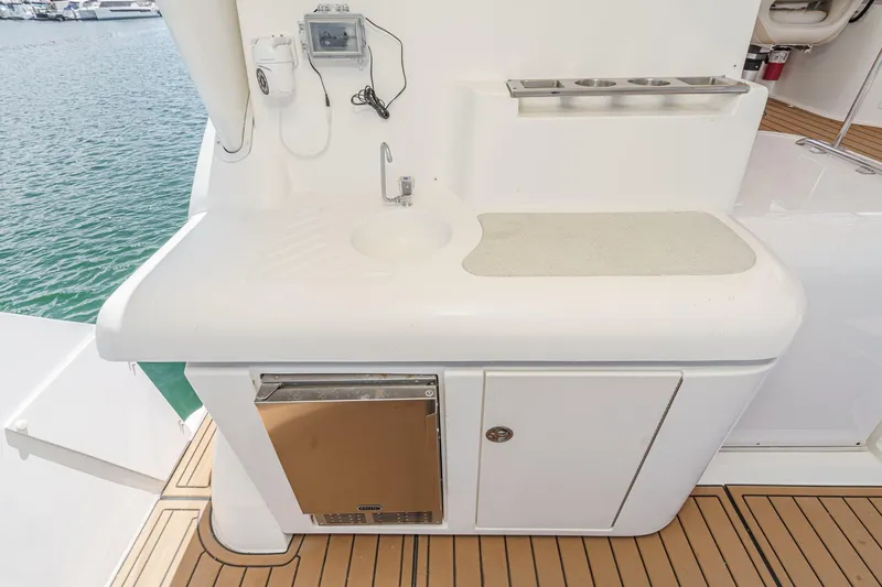 Slide: The Image of 1996 Cruisers Yachts 3650 Aft Cabin kitchenette with sink and storage on deck. - 28
