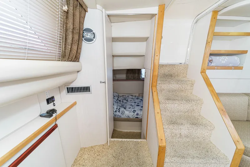 Slide: The Image of Interior of 1996 Cruisers Yachts 3650 Aft Cabin with stairs and cozy sleeping area. - 29