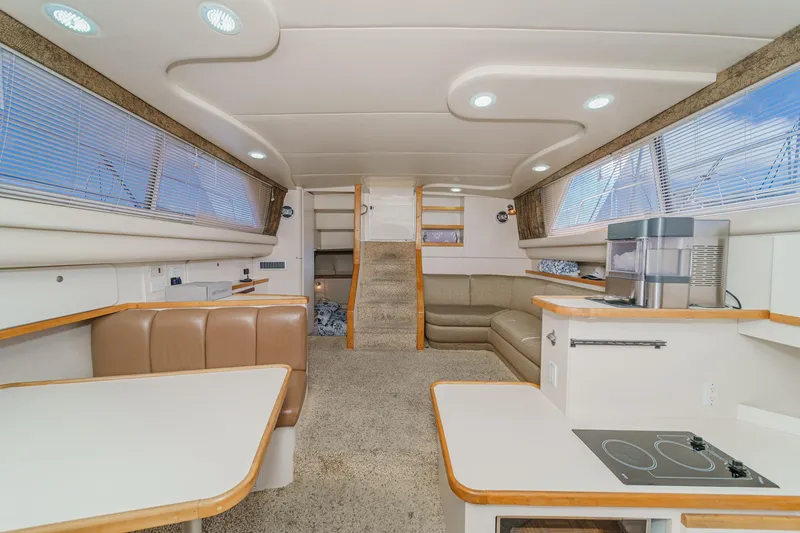 Slide: The Image of Interior of 1996 Cruisers Yachts 3650 Aft Cabin, featuring modern seating and kitchenette. - 31