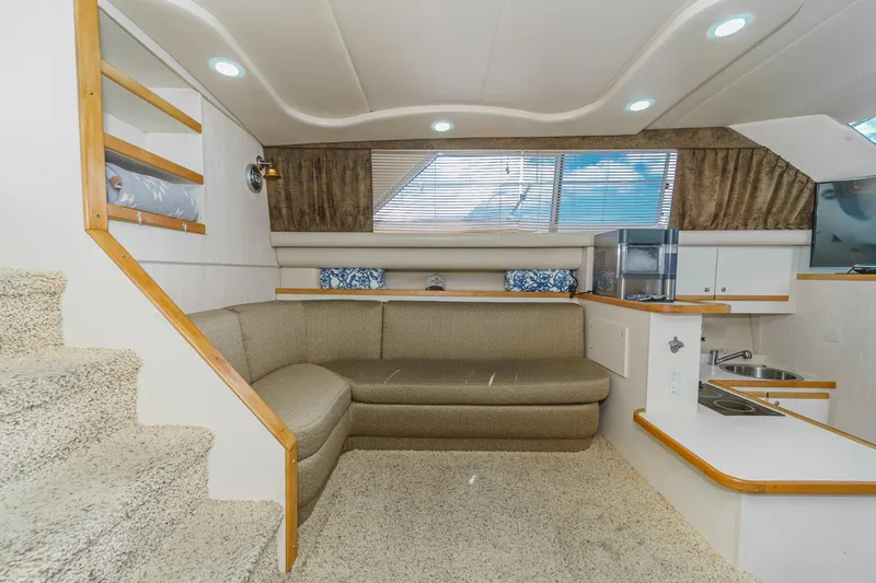 Slide: The Image of Interior of 1996 Cruisers Yachts 3650 Aft Cabin with cozy seating and kitchenette. - 33