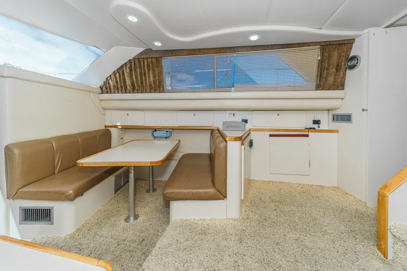Slide: The Image of Interior of 1996 Cruisers Yachts 3650 Aft Cabin with dining area and beige seating. - 34