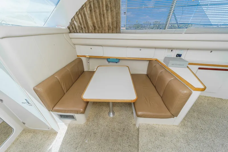 Slide: The Image of 1996 Cruisers Yachts 3650 Aft Cabin interior with beige seating and table. - 37