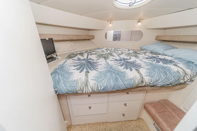 Slide: The Image of 1996 Cruisers Yachts 3650 Aft Cabin bedroom with tropical bedding and cozy lighting. - 39