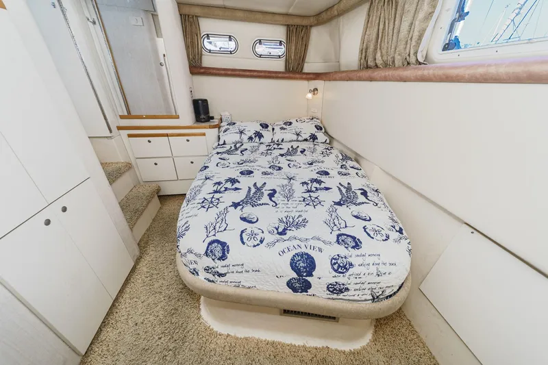Slide: The Image of 1996 Cruisers Yachts 3650 Aft Cabin bedroom with nautical-themed bedding and cozy interior. - 44