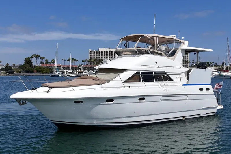 Slide: The Image of 1996 Cruisers Yachts 3650 Aft Cabin in marina, sunny day, calm waters. - 5