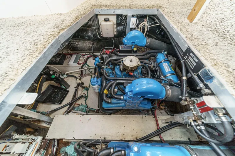 Slide: The Image of Engine room of 1996 Cruisers Yachts 3650 Aft Cabin with blue engine components. - 51