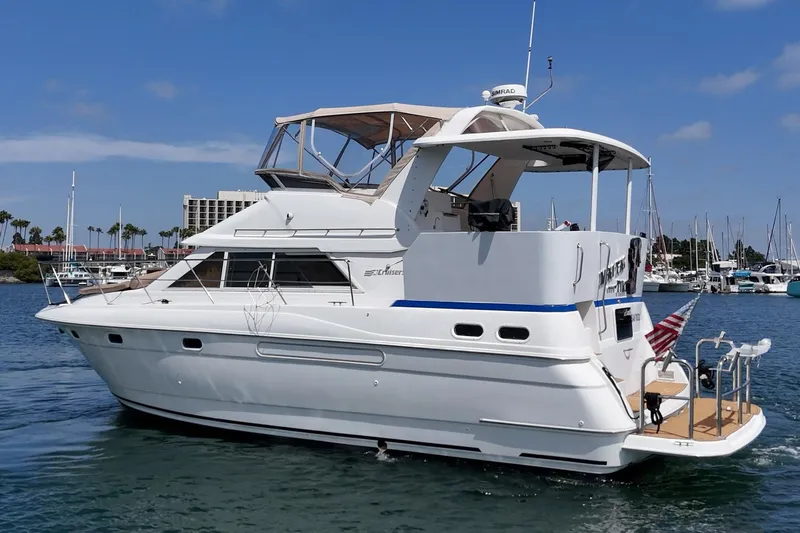 Slide: The Image of 1996 Cruisers Yachts 3650 Aft Cabin on water, showcasing sleek design and spacious deck. - 8