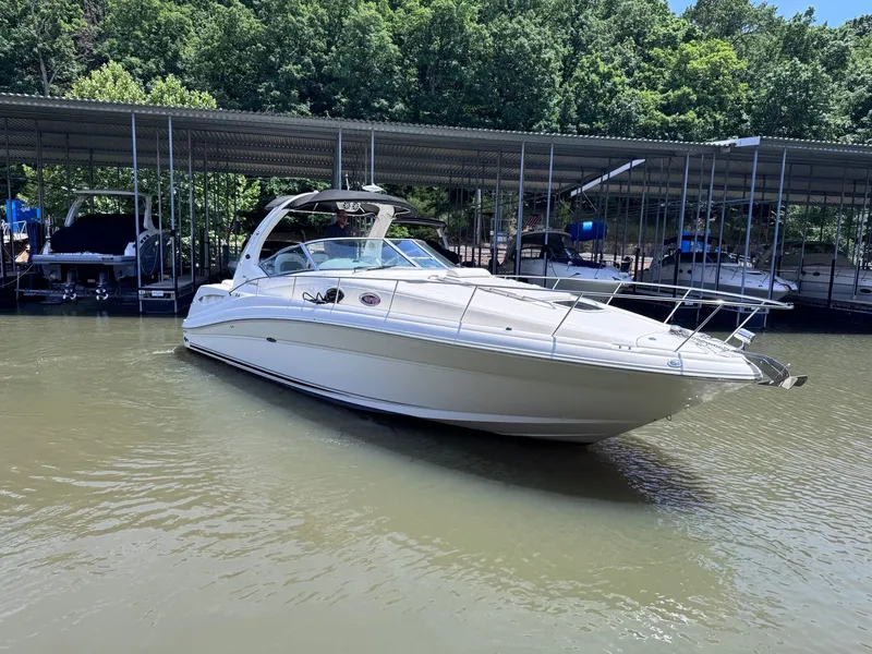 Slide: The Image of 2007 Sea Ray 340 Sundancer on water, surrounded by trees. - 1