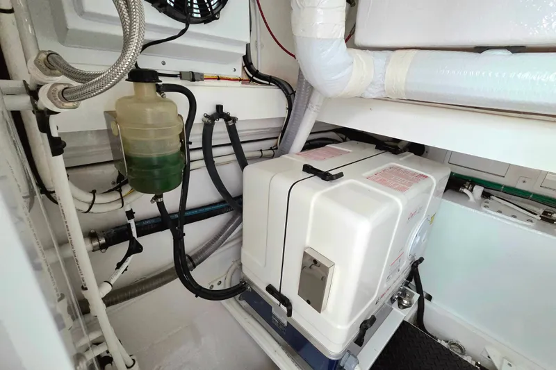 Slide: The Image of Engine room of 2025 Valhalla Boatworks V-46, showcasing mechanical components and piping. - 34