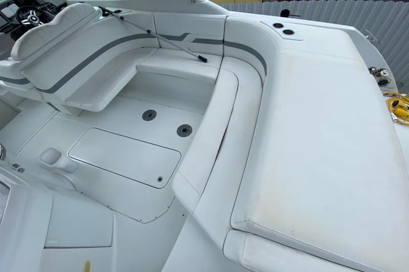 Slide: The Image of 2009 Formula 330 Sun Sport boat interior with white seating and storage compartments. - 11