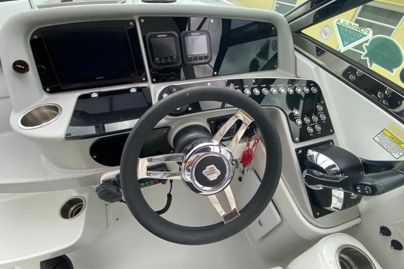 Slide: The Image of 2009 Formula 330 Sun Sport boat dashboard with steering wheel and control panel. - 18