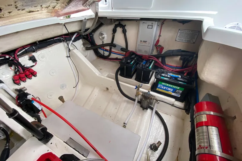 Slide: The Image of Engine compartment of a 2009 Formula 330 Sun Sport boat, featuring batteries and wiring. - 32