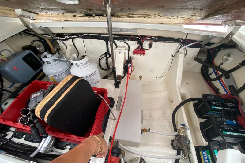 Slide: The Image of Engine compartment of a 2009 Formula 330 Sun Sport boat with propane tanks and batteries. - 34