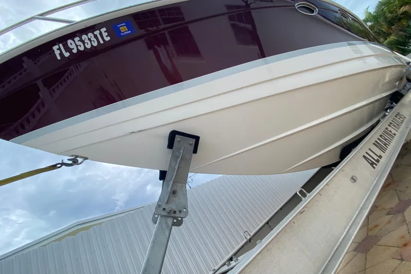 Slide: The Image of 2009 Formula 330 Sun Sport boat on trailer, Florida registration visible. - 4