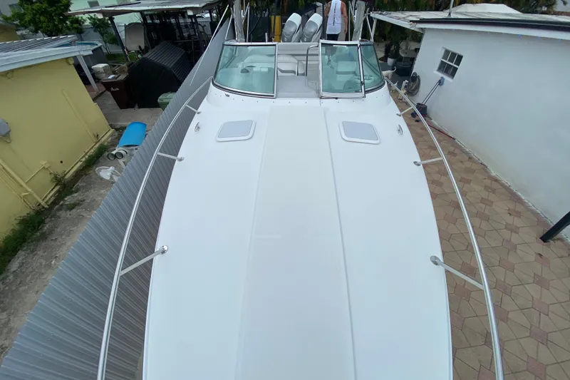 Slide: The Image of 2009 Formula 330 Sun Sport boat, top view, docked beside buildings. - 8