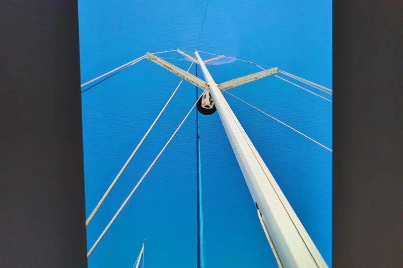 Slide: The Image of Looking up at the mast of a 1990 Catalina 42 sailboat against a clear blue sky. - 31