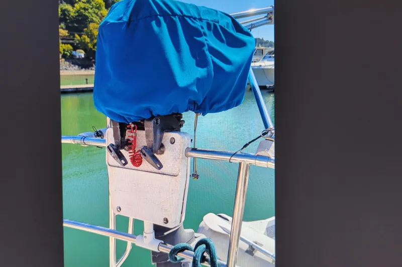 Slide: The Image of Covered outboard motor on a 1990 Catalina 42 sailboat, docked in a marina. - 36