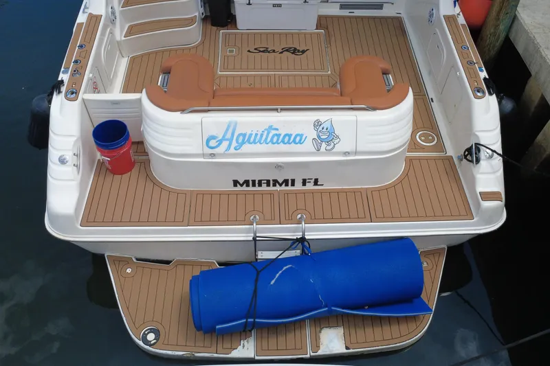 Slide: The Image of The stern of a Sea Ray 450 Express Bridge boat with wooden flooring and a blue mat. - 10