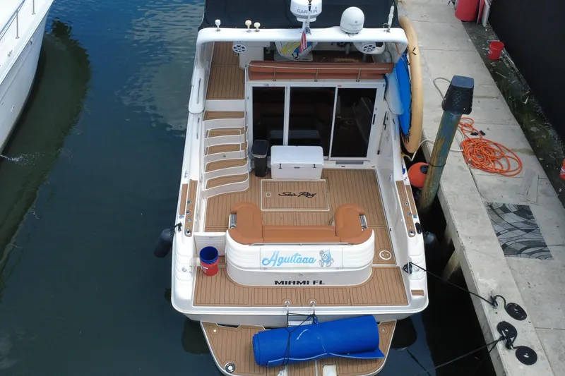 Slide: The Image of A Sea Ray 450 Express Bridge boat docked at a pier. - 11