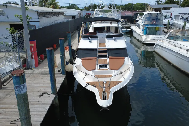Slide: The Image of 1997 Sea Ray 450 Express Bridge docked at marina, aerial view. - 3