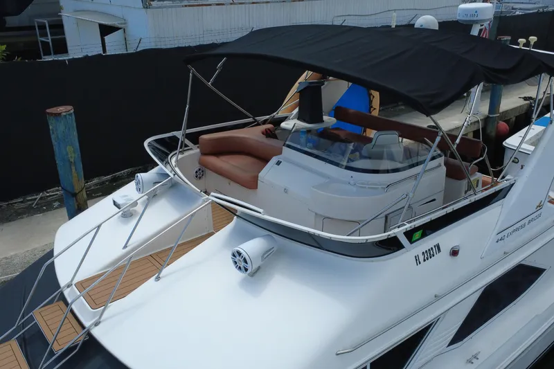 Slide: The Image of 1997 Sea Ray 450 Express Bridge yacht with canopy and seating, docked at marina. - 5