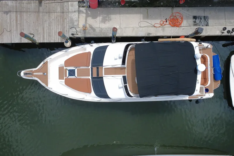 Slide: The Image of Overhead view of a 1997 Sea Ray 450 Express Bridge docked at a marina. - 7