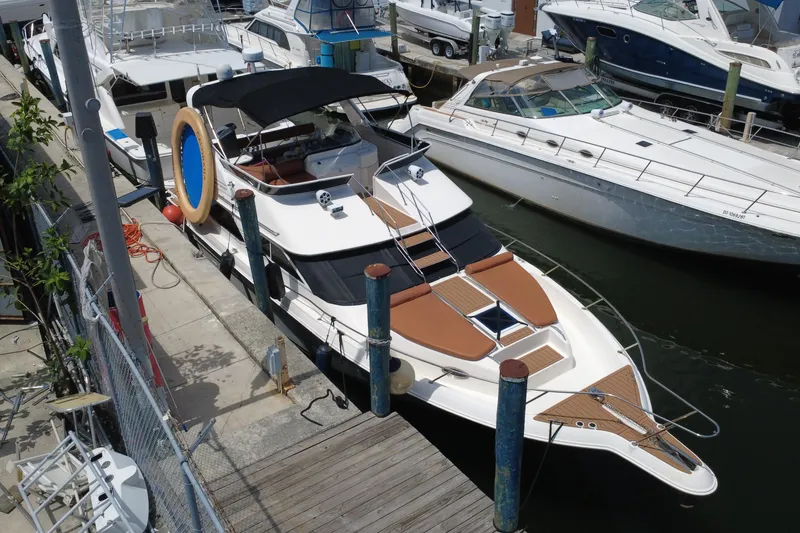Slide: The Image of 1997 Sea Ray 450 Express Bridge yacht docked at marina, aerial view. - 9