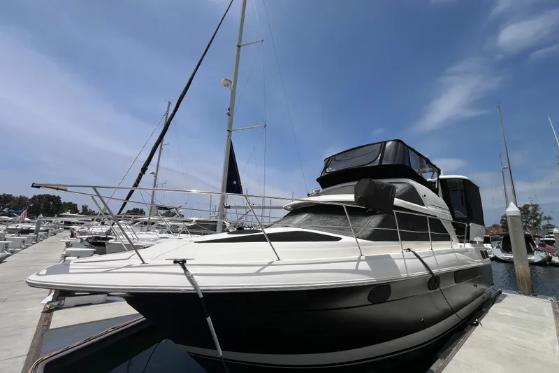 The Image of 1995 Cruisers Yachts 3650 Motoryacht docked at marina under clear sky. - 0