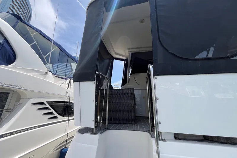 Slide: The Image of 1995 Cruisers Yachts 3650 Motoryacht docked, featuring sleek design and spacious deck area. - 10
