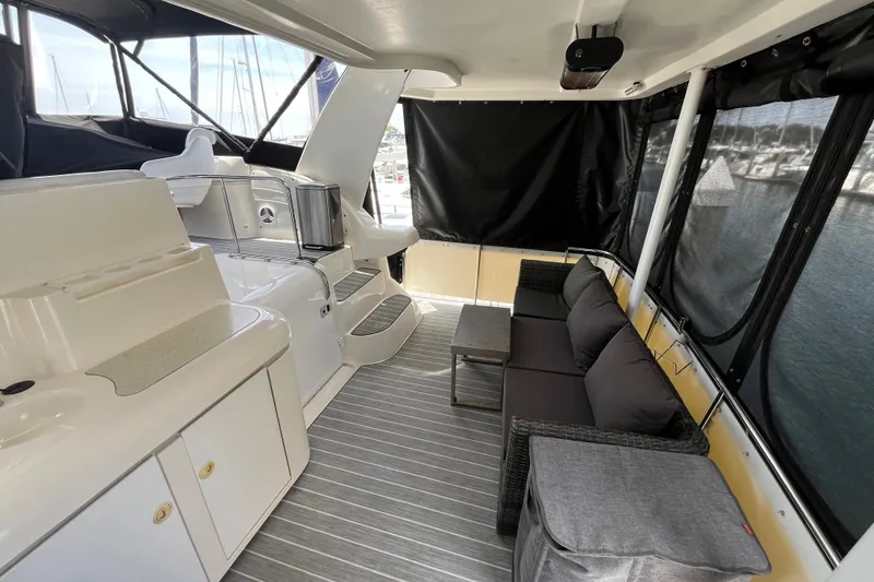 Slide: The Image of 1995 Cruisers Yachts 3650 Motoryacht interior with seating area and kitchenette. - 11