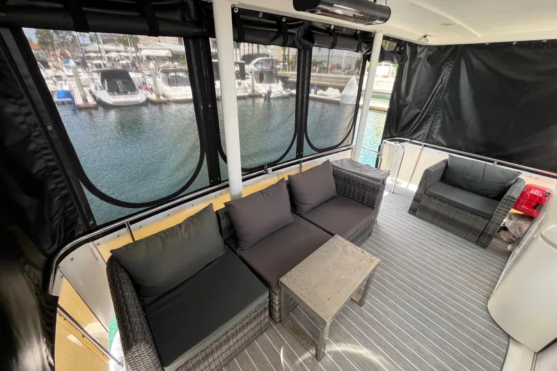 Slide: The Image of Luxurious 1995 Cruisers Yachts 3650 Motoryacht interior with comfortable seating and marina view. - 12