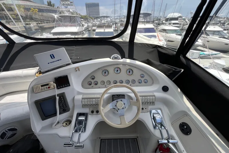 Slide: The Image of Cockpit view of a 1995 Cruisers Yachts 3650 Motoryacht with navigation equipment and steering wheel. - 16