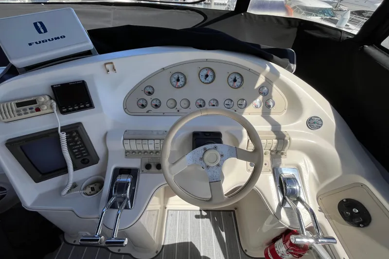Slide: The Image of Cockpit of 1995 Cruisers Yachts 3650 Motoryacht with steering wheel and control panel. - 17