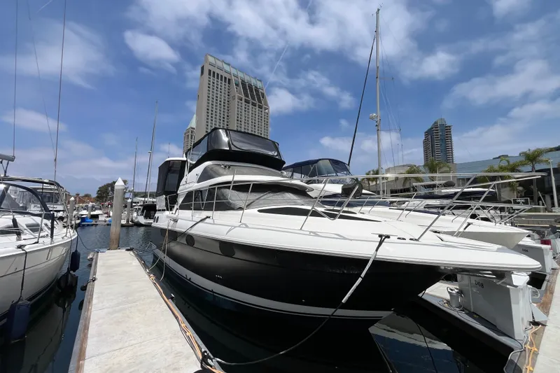 Slide: The Image of 1995 Cruisers Yachts 3650 Motoryacht docked at marina under blue sky. - 2