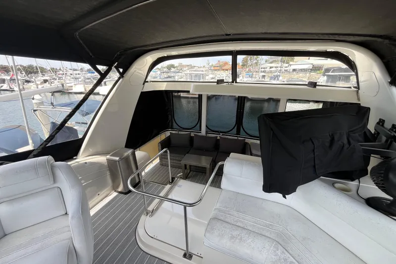 Slide: The Image of 1995 Cruisers Yachts 3650 Motoryacht interior with seating and marina view. - 23