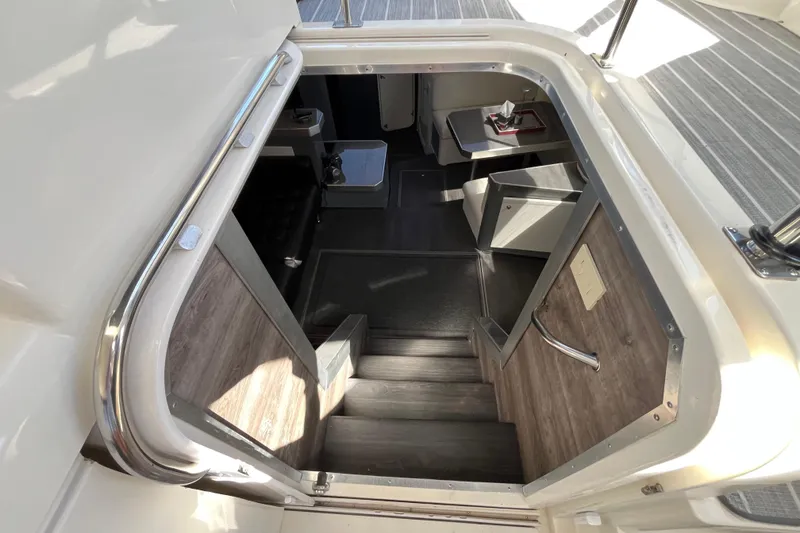 Slide: The Image of Interior view of 1995 Cruisers Yachts 3650 Motoryacht, featuring stairs and seating area. - 24