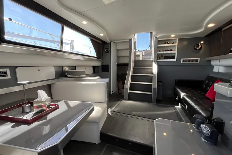 Slide: The Image of Interior of 1995 Cruisers Yachts 3650 Motoryacht, featuring modern seating and ample natural light. - 27
