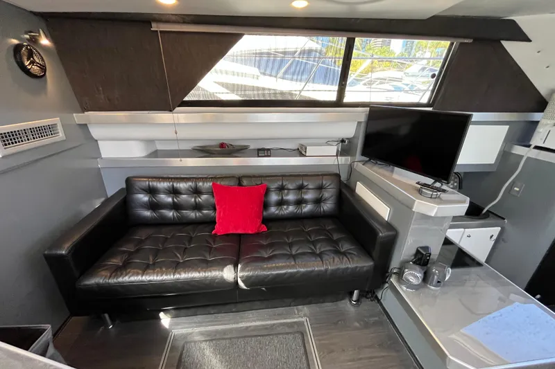 Slide: The Image of Luxurious interior of 1995 Cruisers Yachts 3650 Motoryacht with black leather sofa and TV. - 28